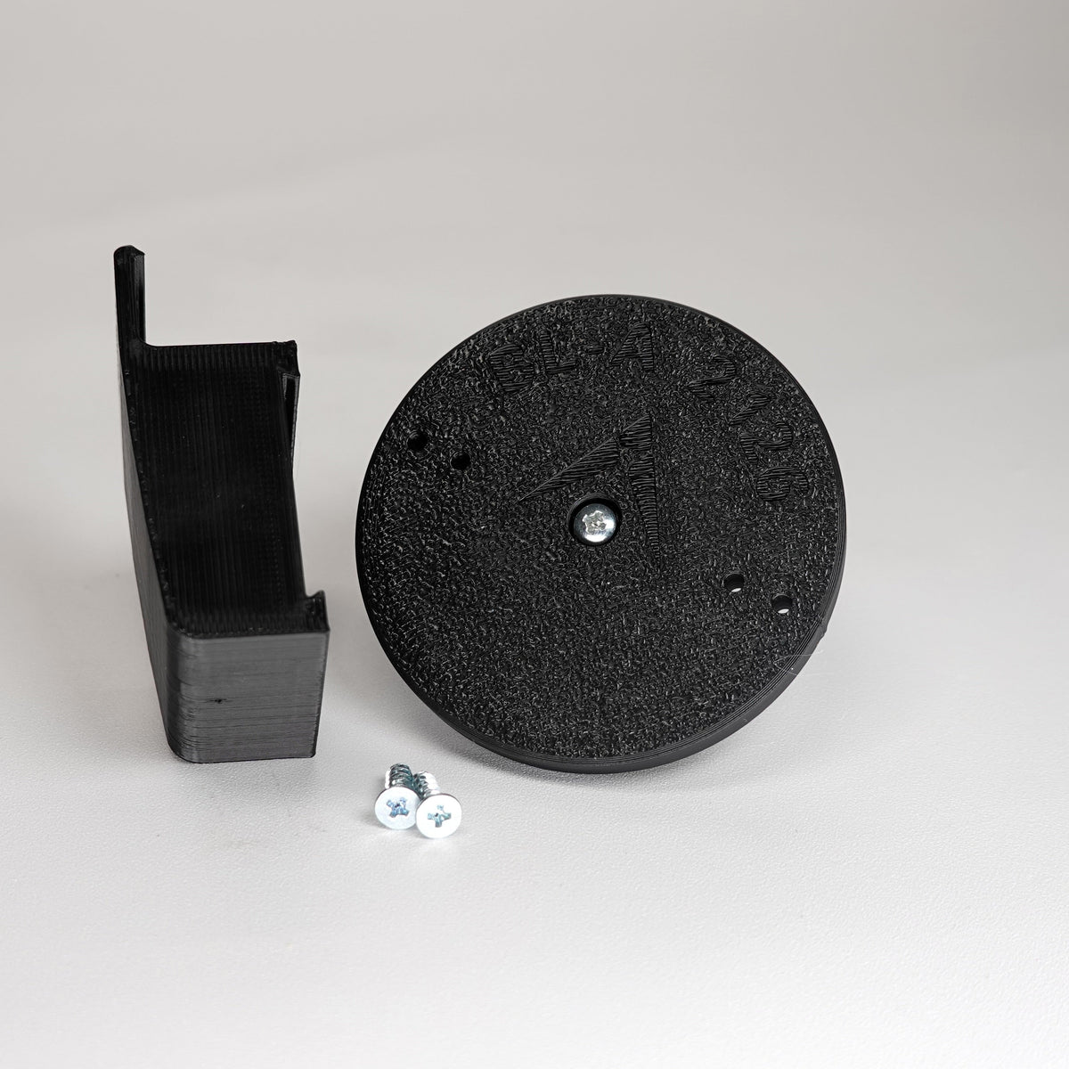 3D-printed traditional vinyl siding clip and circular mounting base for a Blink camera, include screws.