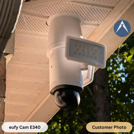 white eufy Floodlight Cam E340 installed using a 3D-printed vertical drop extension mount.