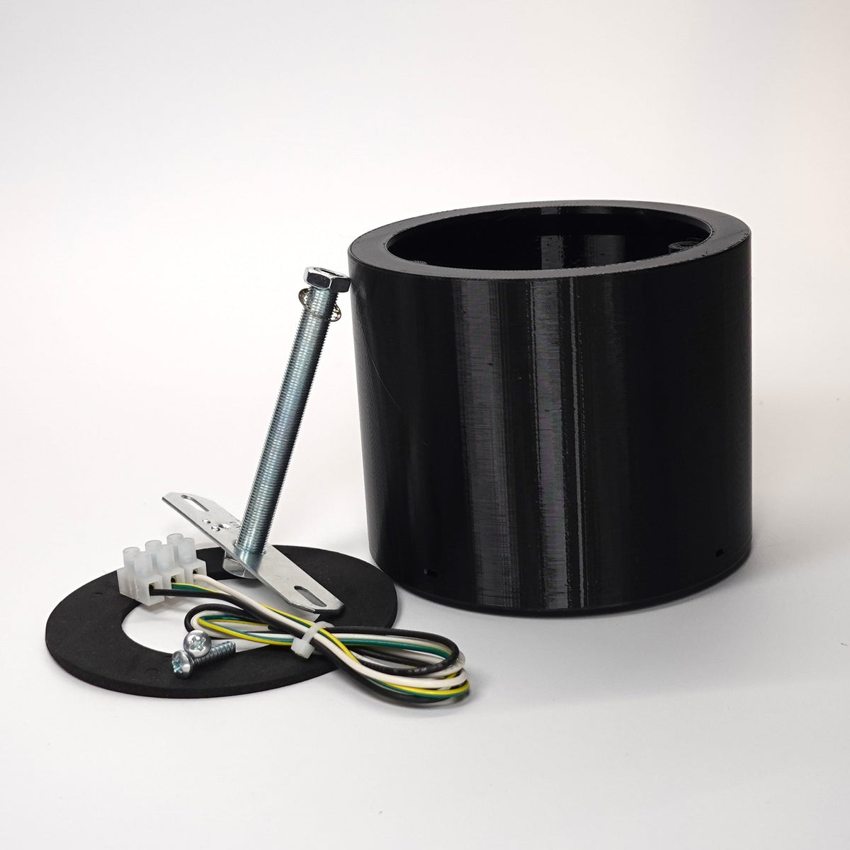 Black 100mm cylindrical wall standoff extension for floodlight cameras.