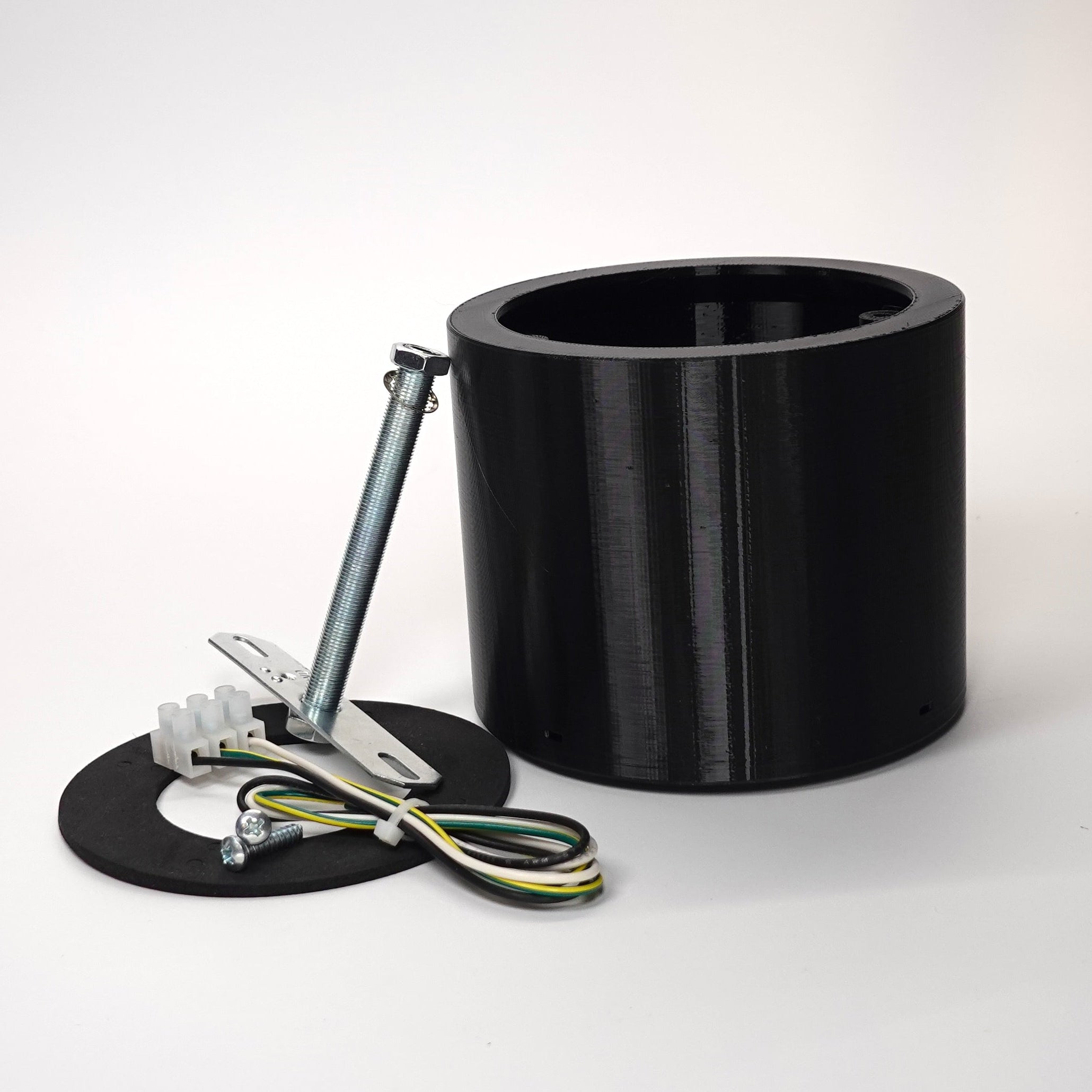 Black 100mm cylindrical wall standoff extension for floodlight cameras.