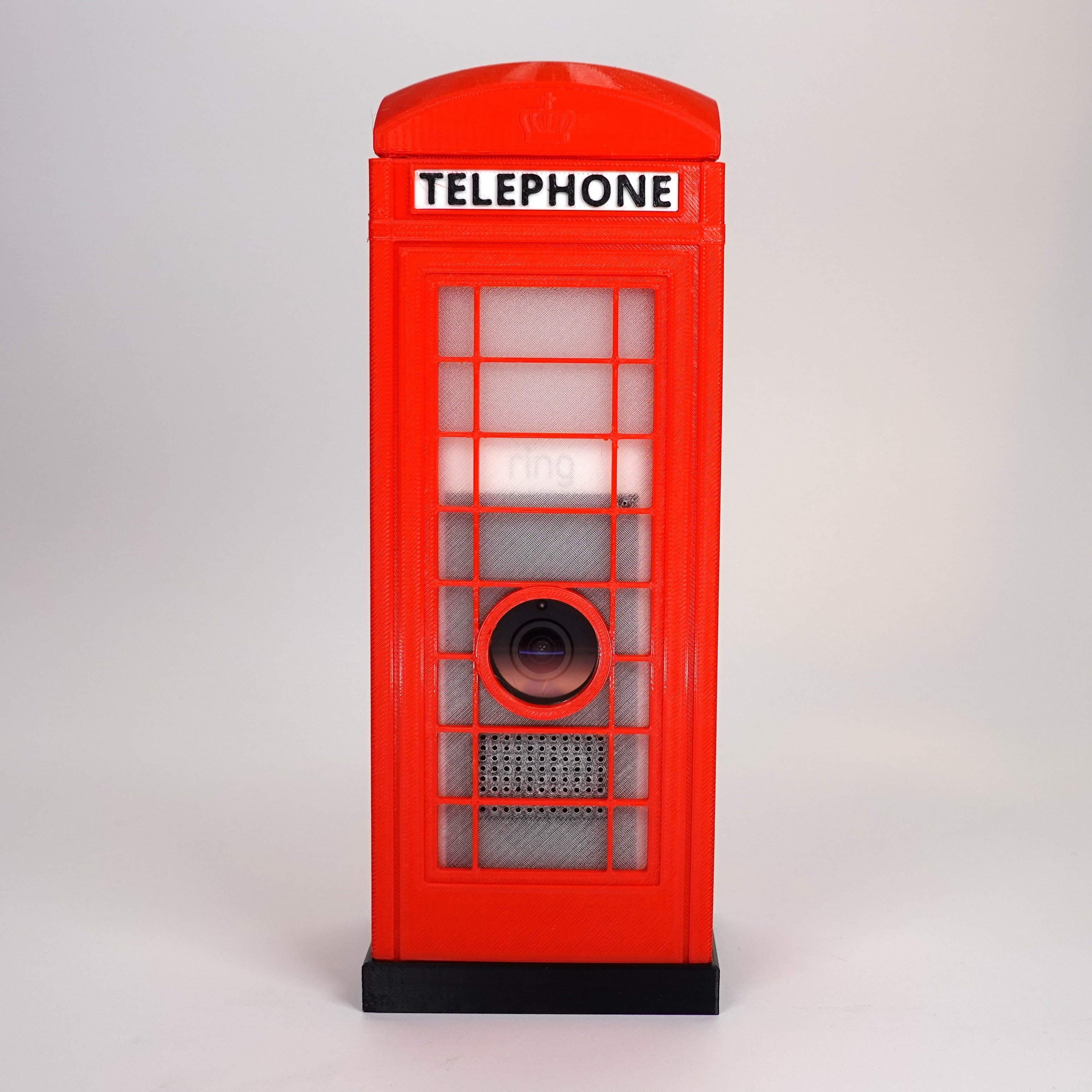 Front-facing view of a red 3D-printed London K6 telephone box decorative case designed to hide a Ring Stick Up Cam Pro.