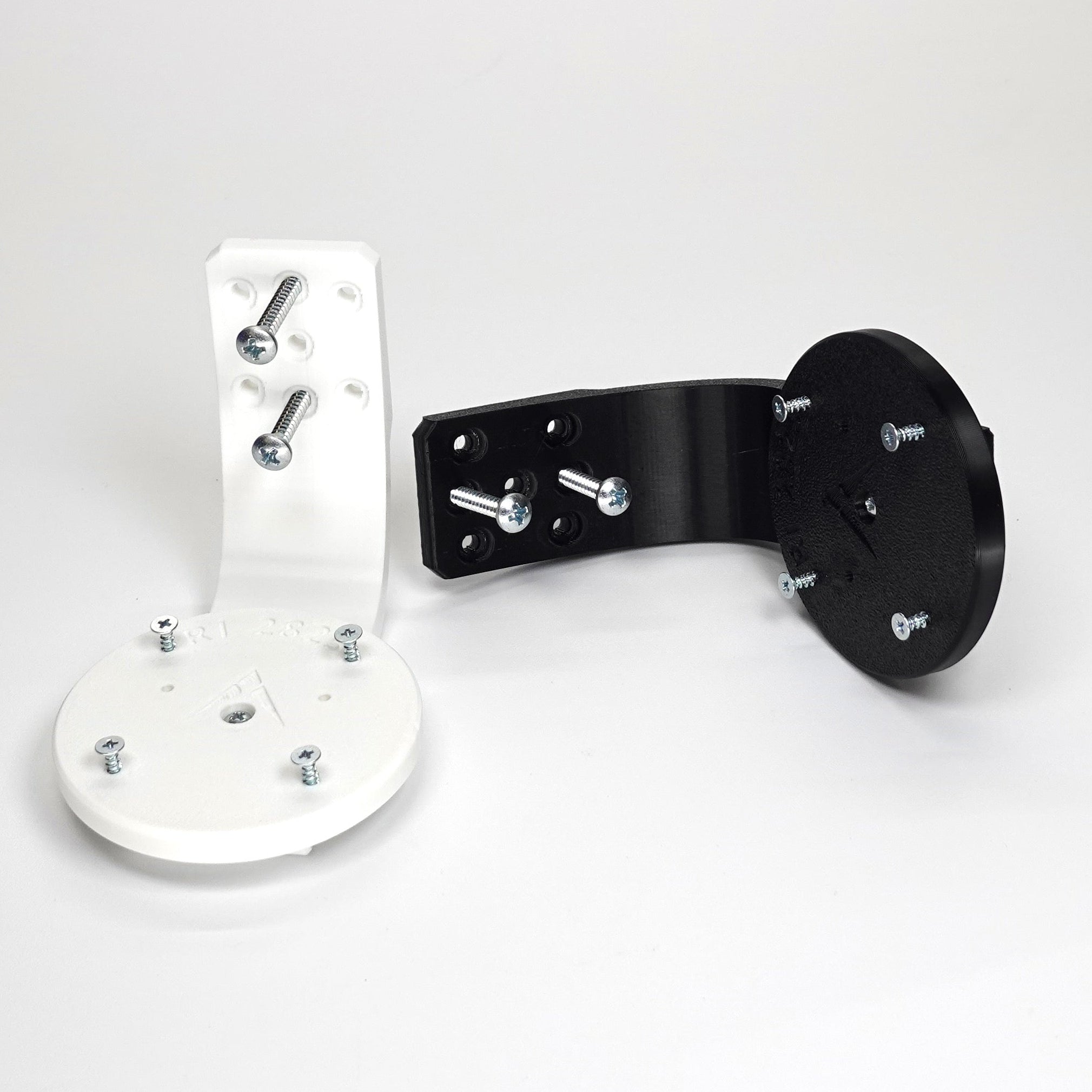 3D-printed Ring camera mounts in black and white, featuring curved arm brackets, and included installation screws.