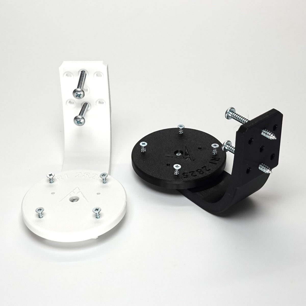 3D-printed Ring camera mounts in black and white, featuring curved arm brackets, and included installation screws.