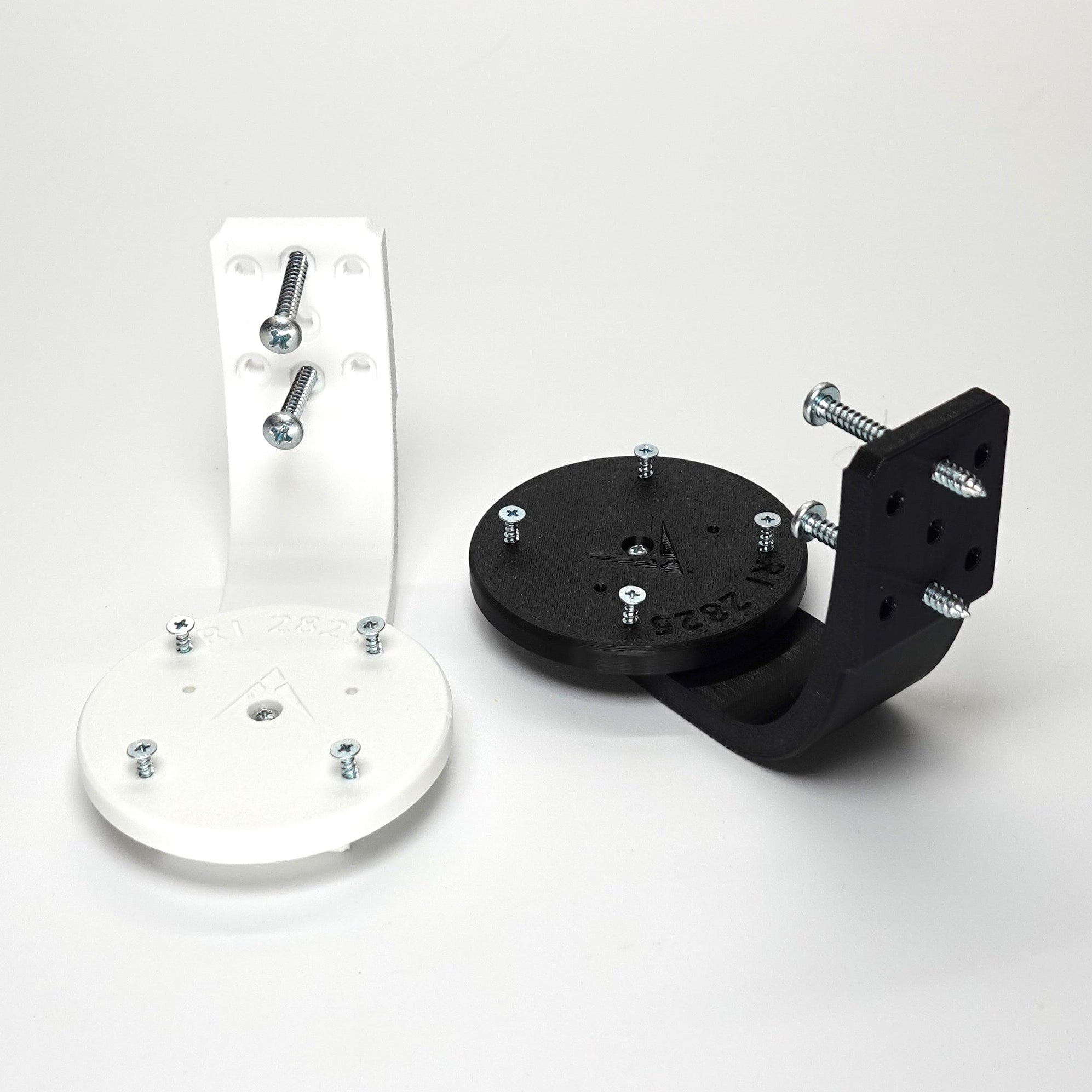 3D-printed Ring camera mounts in black and white, featuring curved arm brackets, and included installation screws.