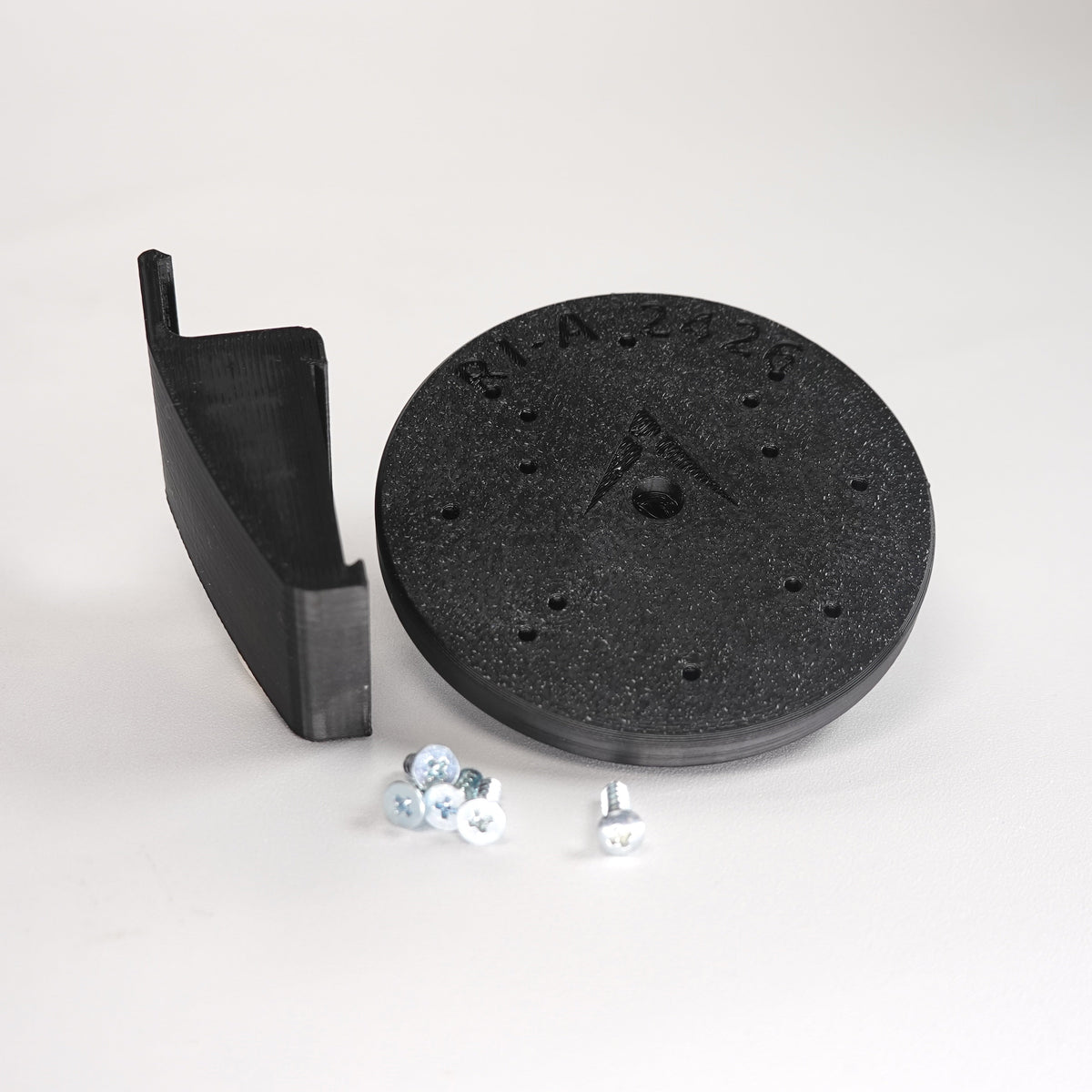 Black 3D-printed Dutch Lap siding clip and circular mounting plate for ring Cam Siding Clips, include five mounting screws.