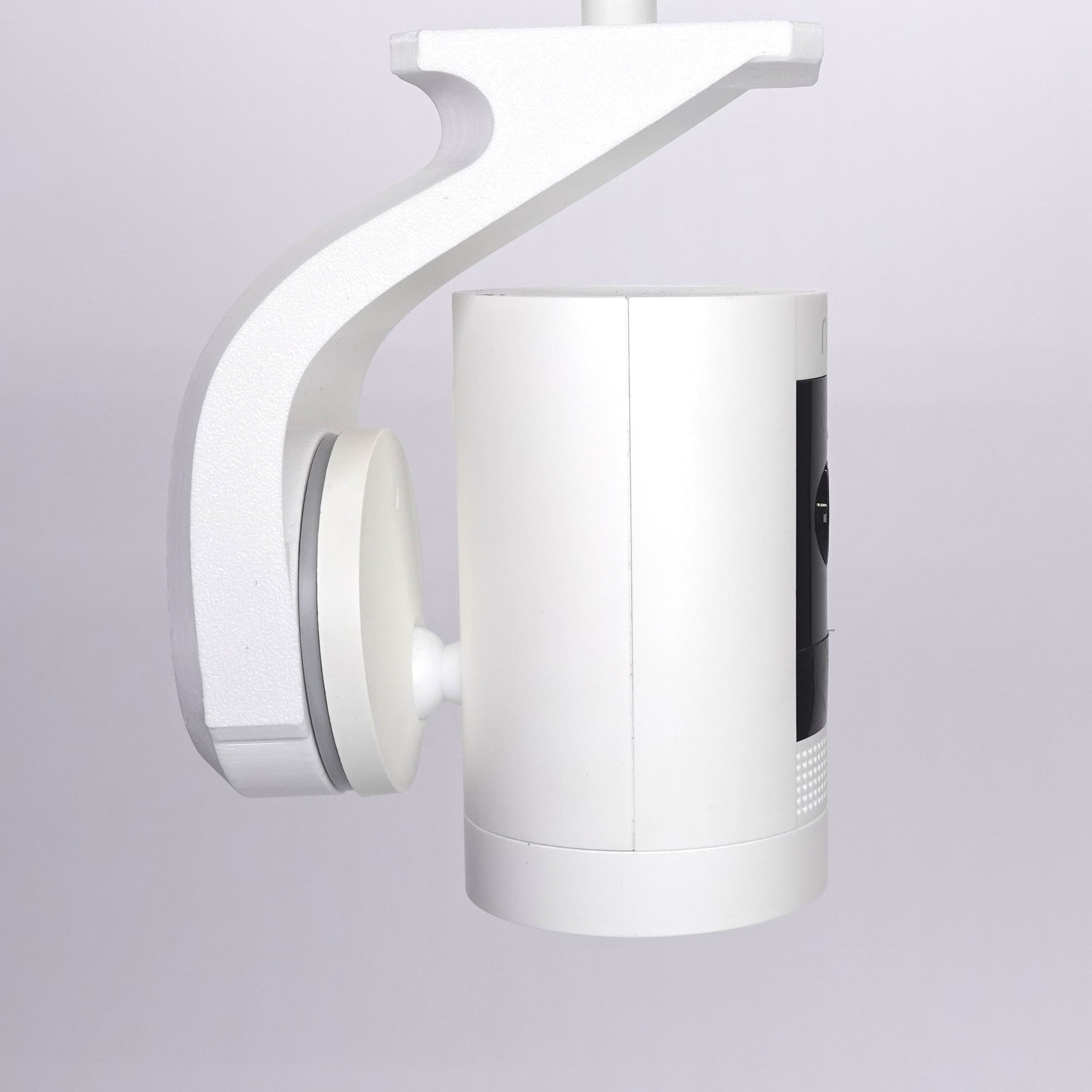 Side view of a white 3D-printed Ring Stick Up Cam soffit mount.