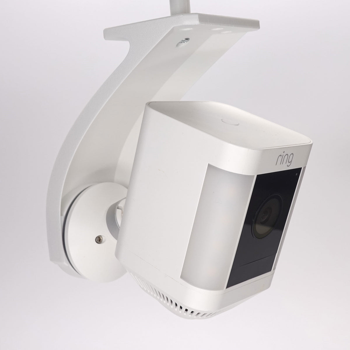 Side view of a white 3D-printed Ring Stick Up Cam soffit mount.