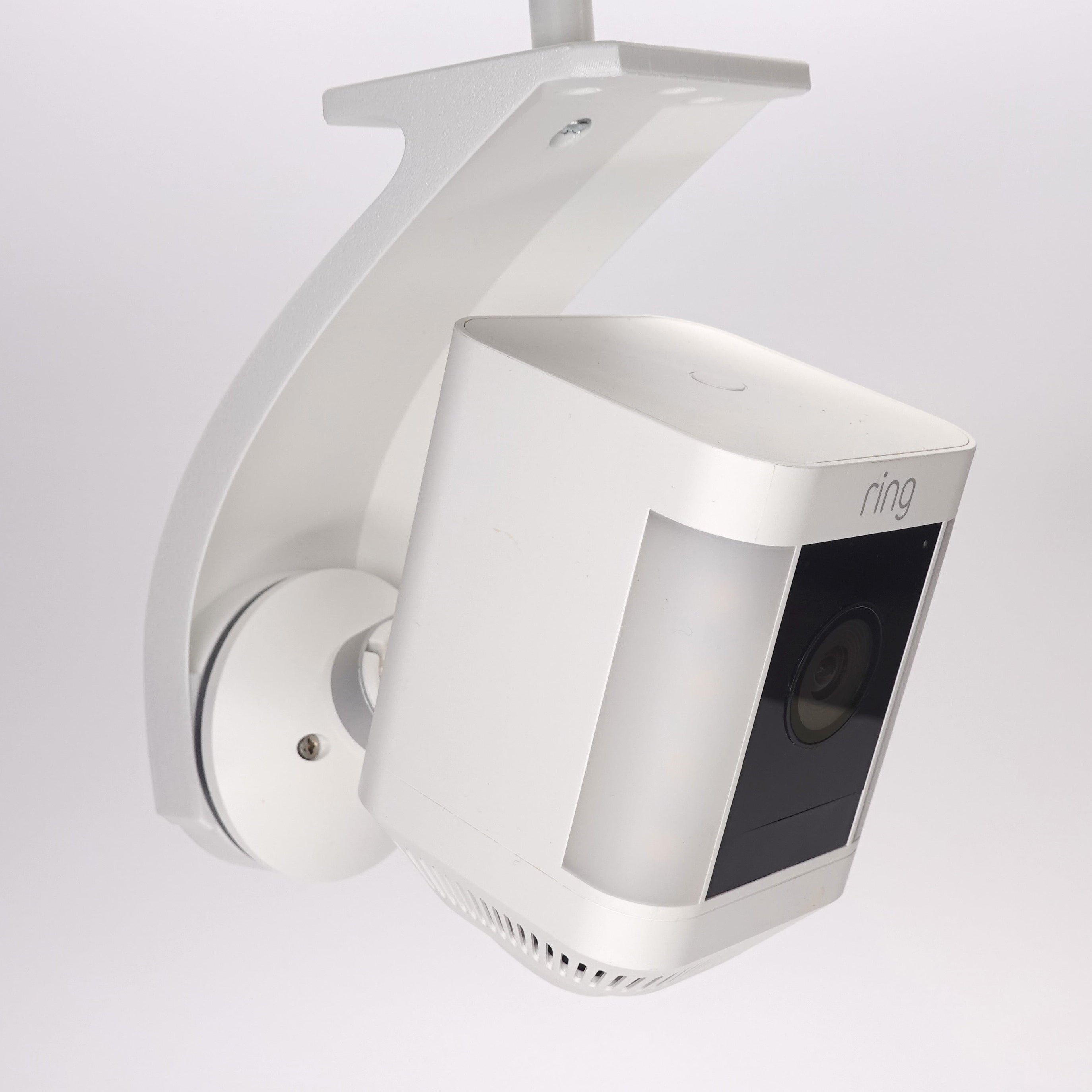 Side view of a white 3D-printed Ring Stick Up Cam soffit mount.