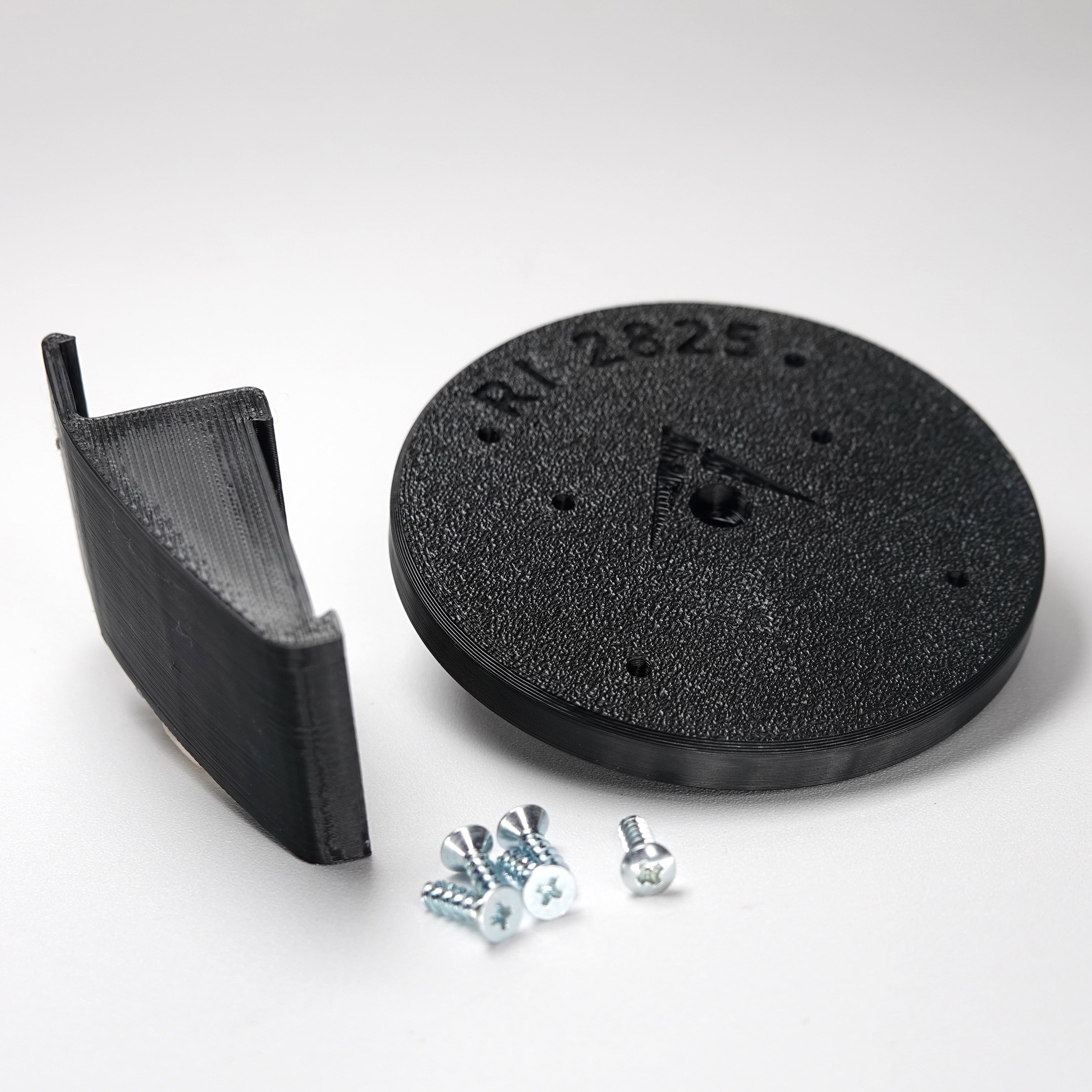 Black 3D-printed Dutch Lap siding clip and circular mounting plate for ring Cam Siding Clips, include five mounting screws.